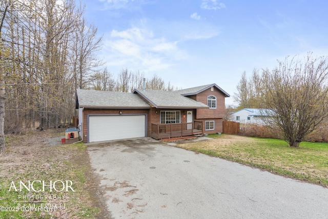 view of front of property with a porch, a front yard, and a garage