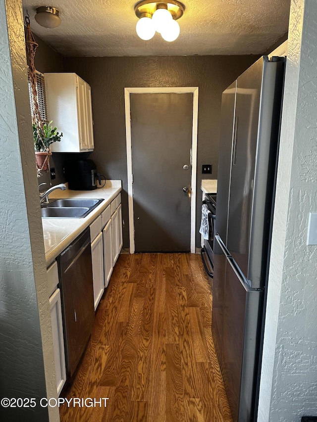 8281 Stratton Cir, Anchorage, AK 99507 - kitchen with appliances with stainless steel finishes, a textured wall, a textured ceiling, light countertops, and white cabinets