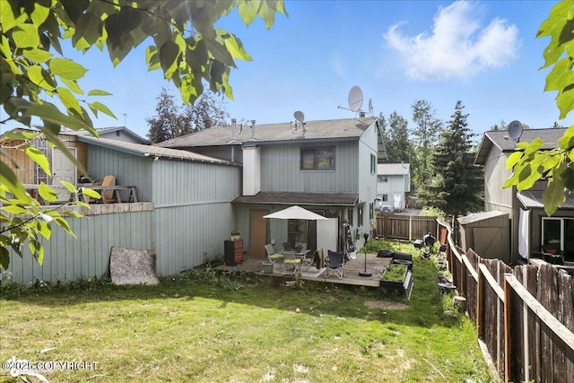 8281 Stratton Cir, Anchorage, AK 99507 - back of house featuring a fenced backyard, a wooden deck, and a shingled roof