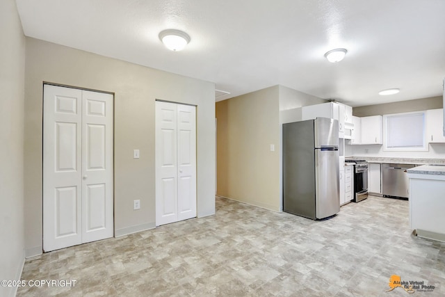 kitchen featuring white cabinetry and appliances with stainless steel finishes