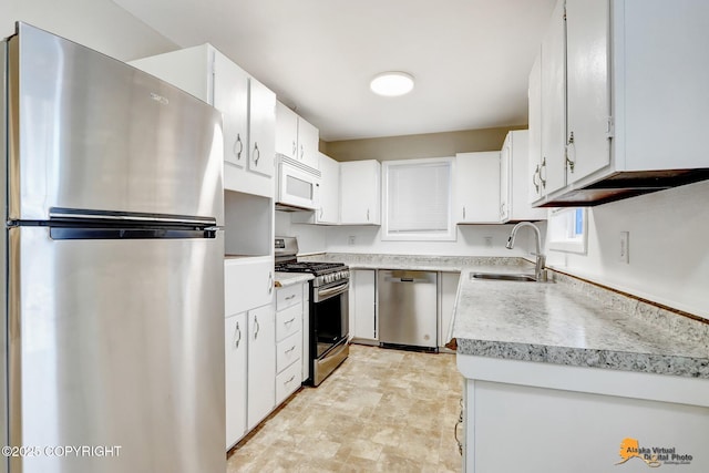 kitchen featuring sink, white cabinets, and stainless steel appliances