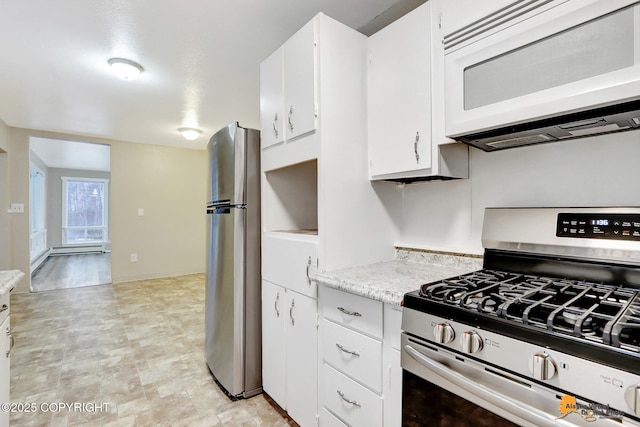 kitchen with white cabinets, appliances with stainless steel finishes, and a baseboard radiator