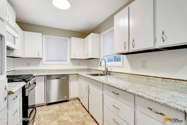 kitchen with sink, white cabinetry, and stainless steel appliances