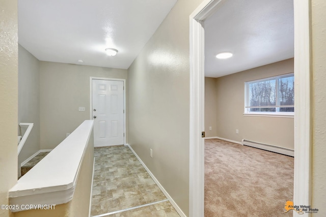 corridor with light colored carpet and a baseboard radiator