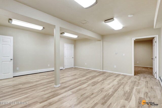 basement with light hardwood / wood-style floors