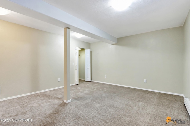 basement featuring carpet flooring and baseboard heating