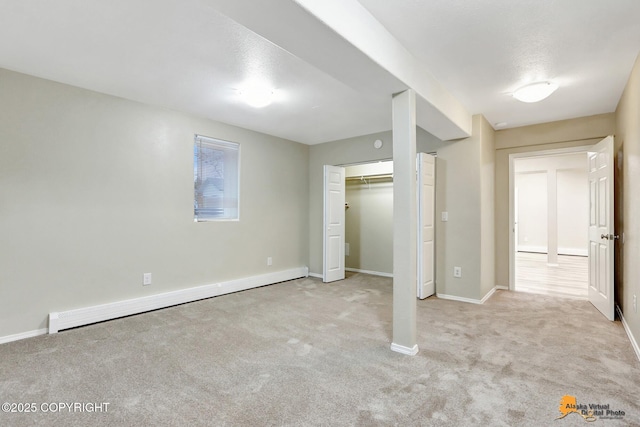 unfurnished bedroom featuring light carpet and a baseboard radiator