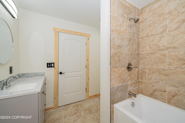 bathroom with vanity and tiled shower / bath