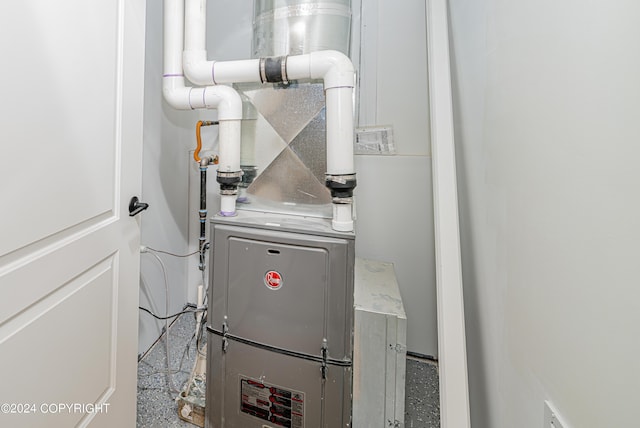 utility room featuring heating unit