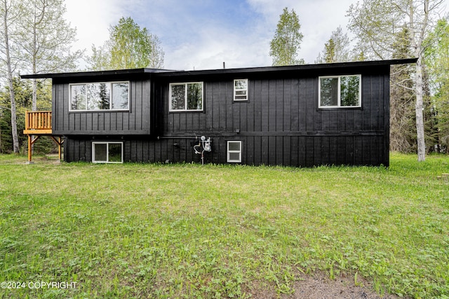 rear view of property with a lawn