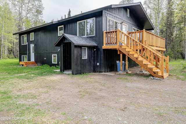 back of house featuring a deck