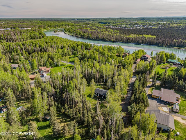 aerial view at dusk featuring a water view