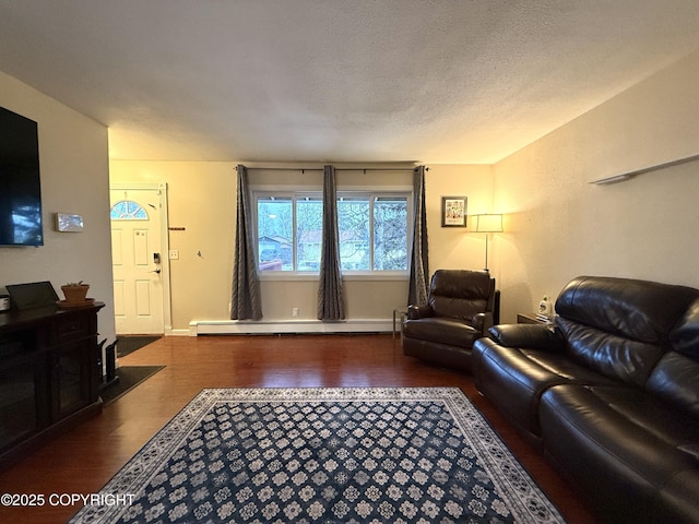 living room featuring wood-type flooring, a baseboard heating unit, and a textured ceiling