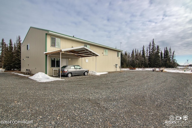 back of property with a carport