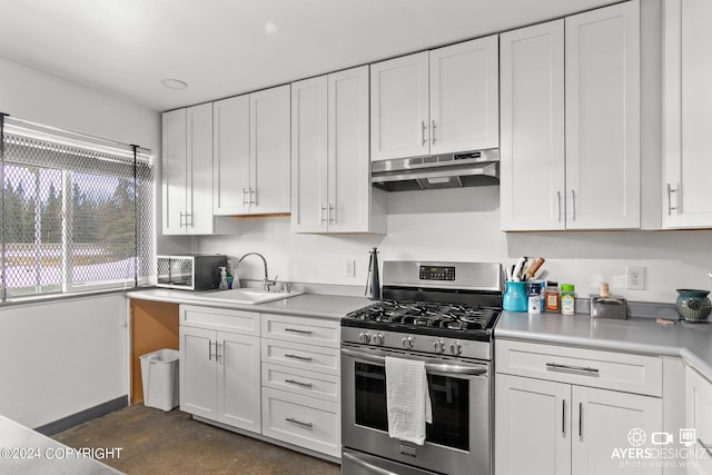 kitchen featuring white cabinetry, stainless steel gas range oven, and sink