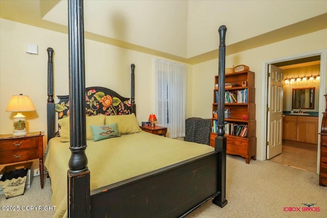 carpeted bedroom with connected bathroom and sink