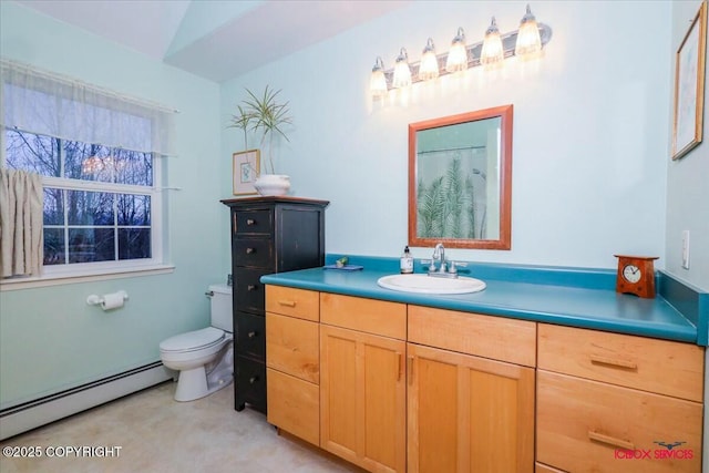 bathroom with toilet, vanity, a baseboard heating unit, and vaulted ceiling