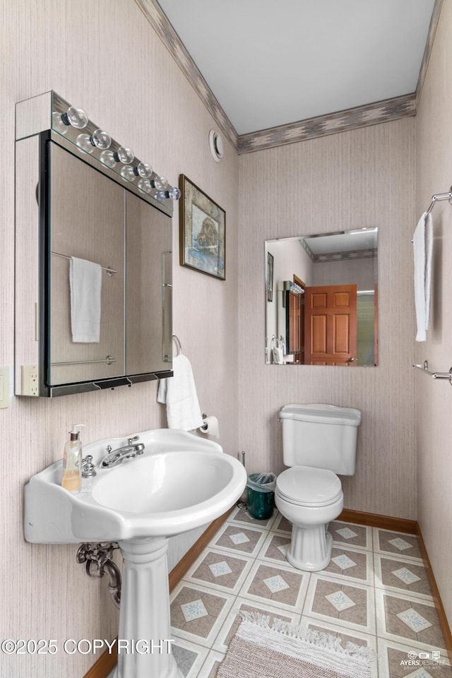 bathroom with tile patterned flooring, toilet, and ornamental molding