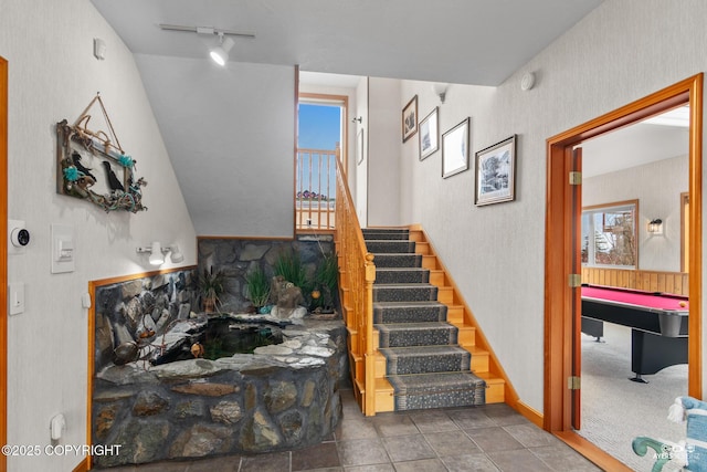 stairway featuring rail lighting and billiards