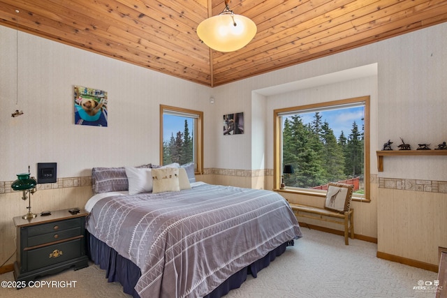 bedroom featuring light colored carpet, lofted ceiling, and wood ceiling