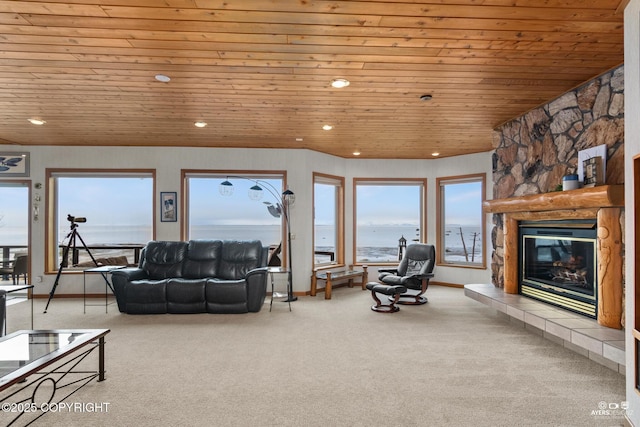 living room with a fireplace, a water view, light colored carpet, and wood ceiling