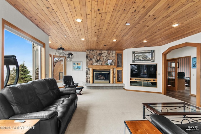 living room with carpet flooring, a fireplace, and wooden ceiling