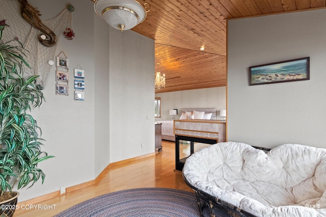 interior space with hardwood / wood-style flooring, lofted ceiling, wooden ceiling, and a fireplace