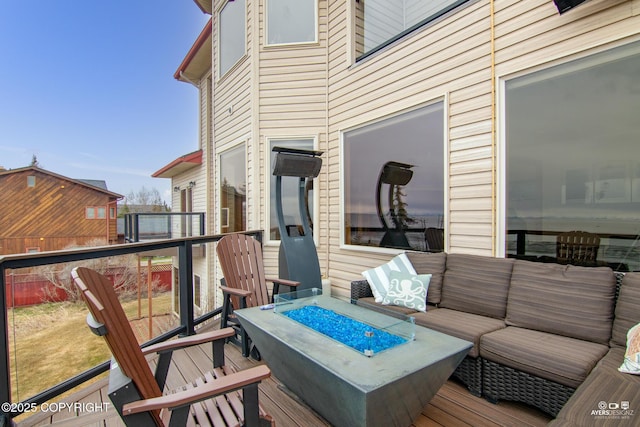 wooden deck with an outdoor living space with a fire pit