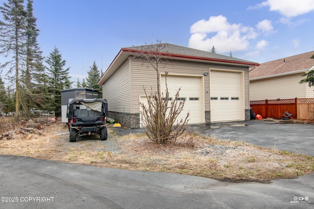 exterior space with a garage and an outdoor structure