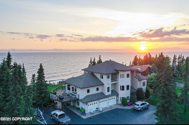 aerial view at dusk with a water view