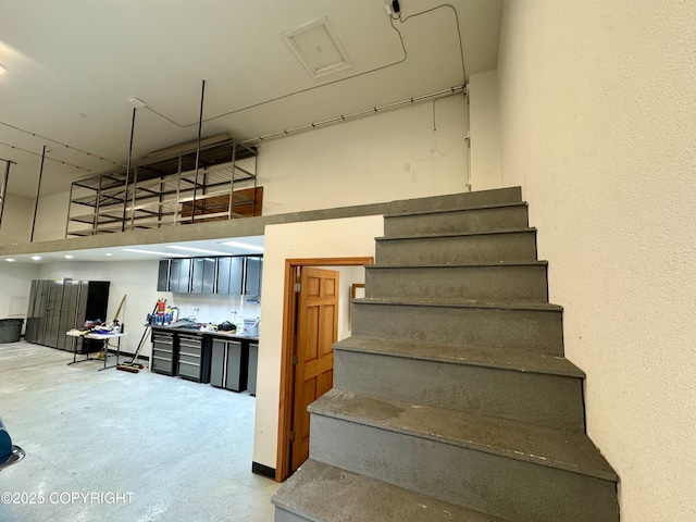 36575 Chinulna Dr, Kenai, AK 99611 - staircase with a high ceiling and concrete floors