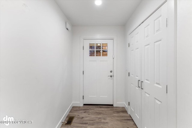 doorway to outside with wood-type flooring