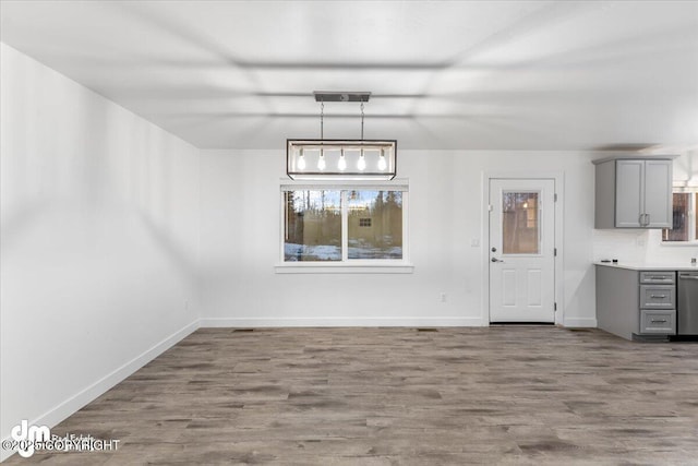 unfurnished dining area featuring hardwood / wood-style flooring