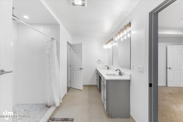 bathroom with curtained shower and vanity