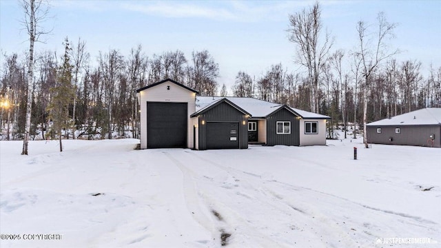 view of front of home featuring a garage and an outdoor structure