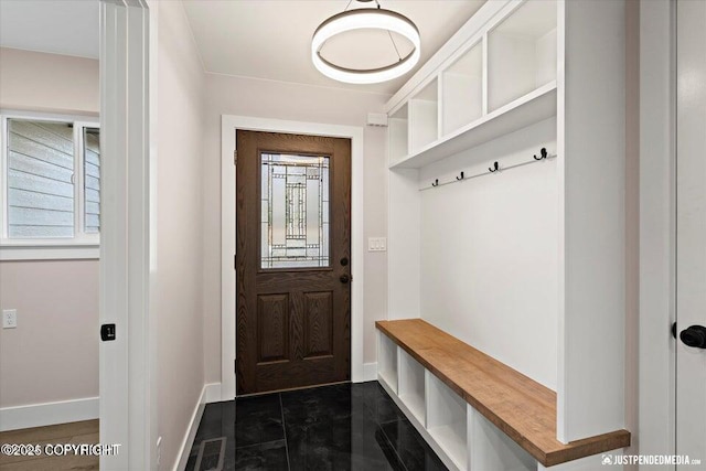 mudroom featuring dark tile patterned flooring