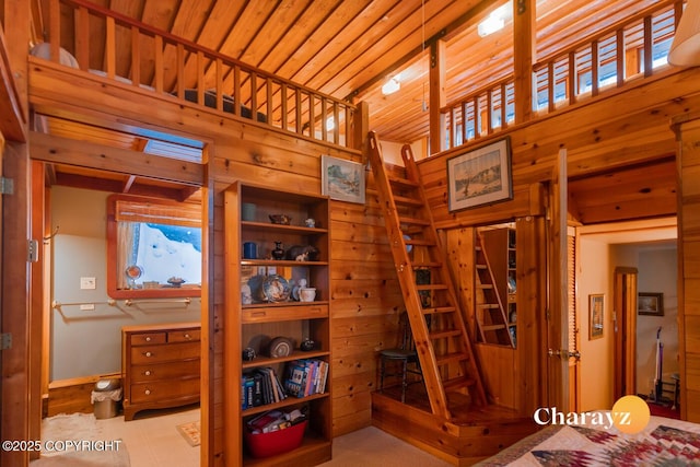 bedroom with wooden walls and wood ceiling