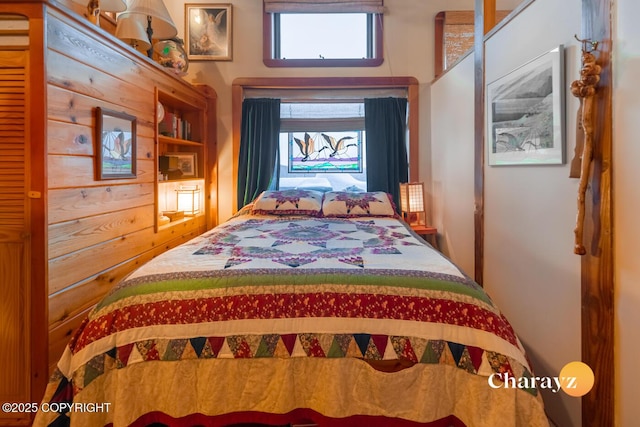 bedroom with wood walls