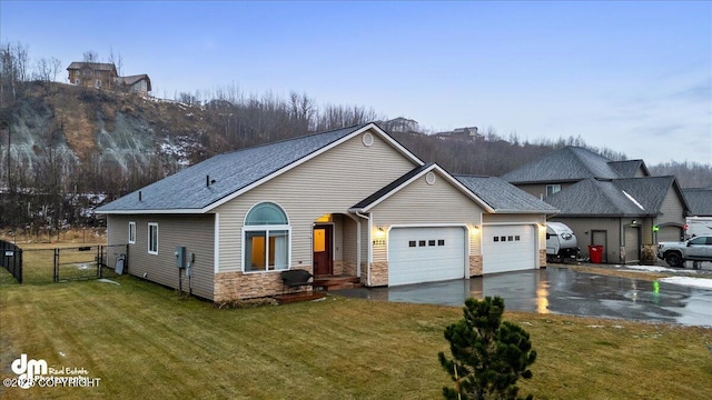 view of front of home with a garage and a front lawn