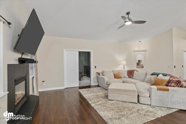 living room with dark hardwood / wood-style flooring and ceiling fan