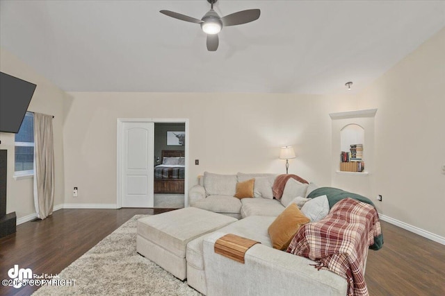 living room with dark hardwood / wood-style floors and ceiling fan