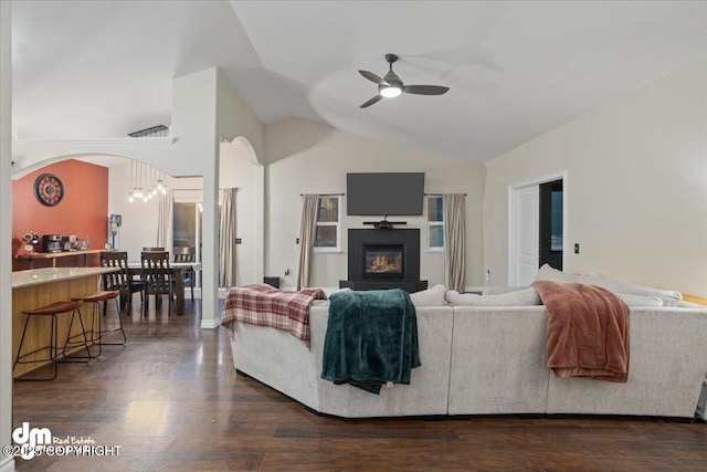 living room with vaulted ceiling, ceiling fan, and dark wood-type flooring