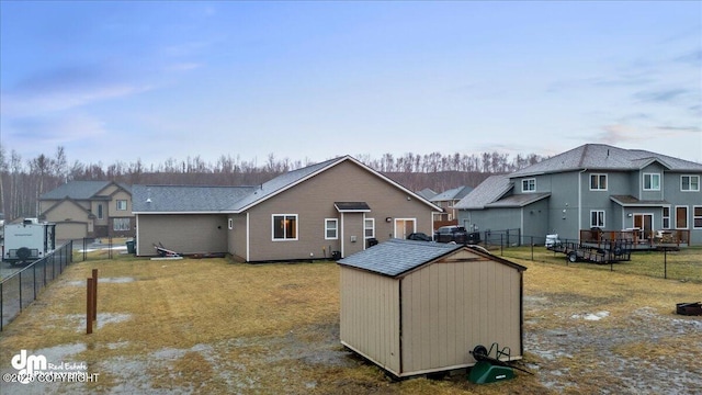 rear view of house with a storage unit