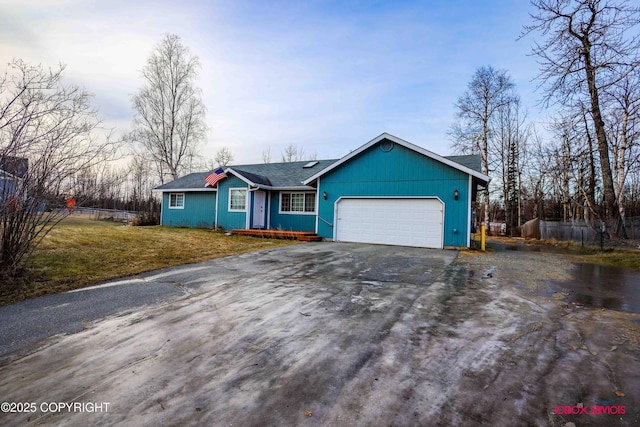 single story home with a front lawn and a garage