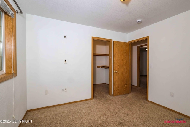 unfurnished bedroom featuring carpet floors and a textured ceiling