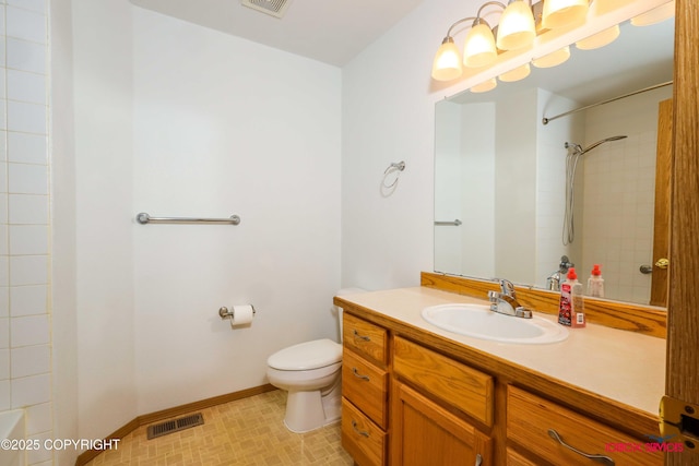 bathroom featuring vanity, toilet, and a shower