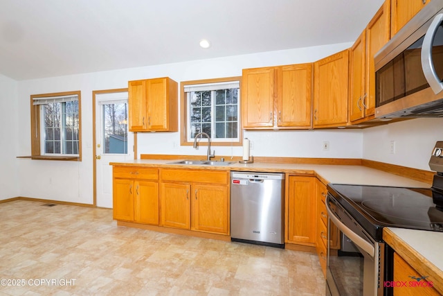 kitchen with sink and appliances with stainless steel finishes