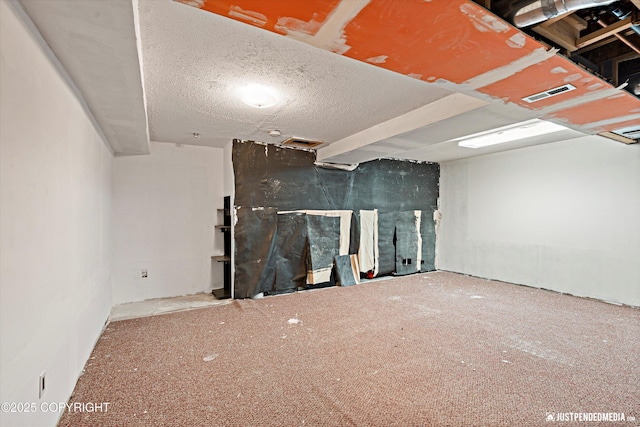 basement featuring a textured ceiling