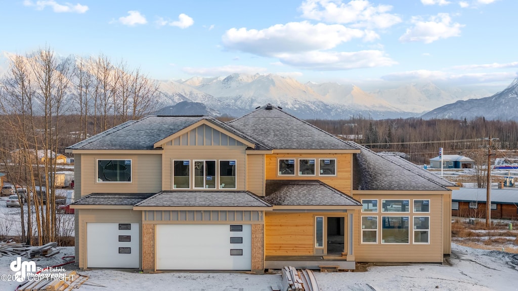 view of front facade with a garage and a mountain view