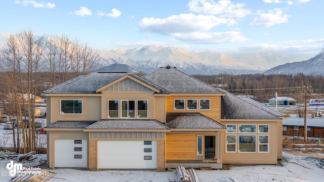 view of front facade with a garage and a mountain view